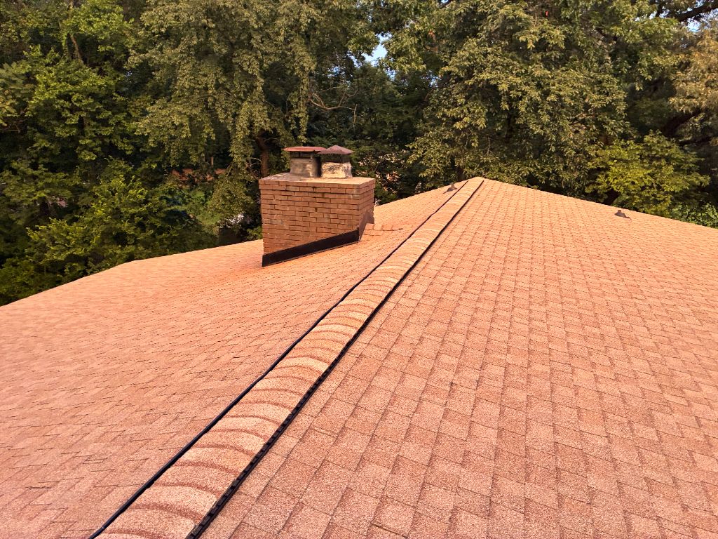After: close-up of a new dimensional shingle roof around the same chimney